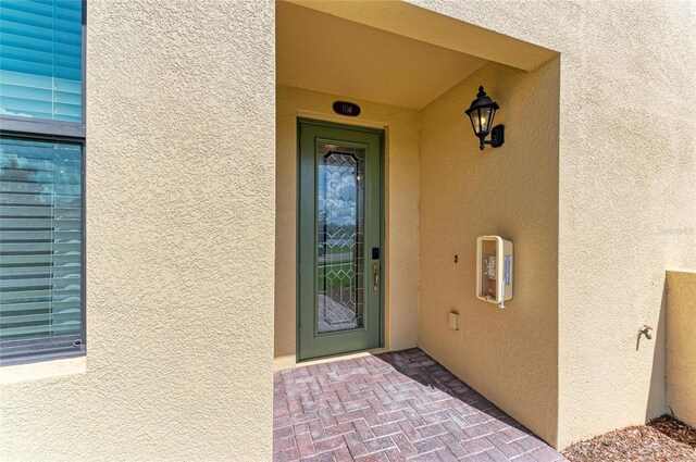 6907 Grand Estuary Trl Unit 104, Bradenton, FL 34212 - view of exterior entry with stucco siding