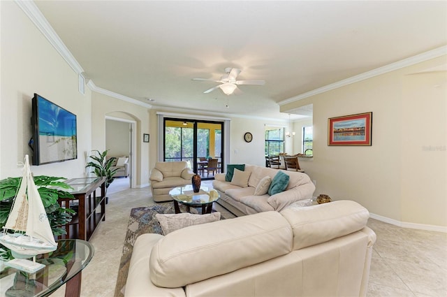 6907 Grand Estuary Trl Unit 104, Bradenton, FL 34212 - living room with crown molding, arched walkways, ceiling fan, light tile patterned flooring, and baseboards