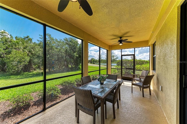 6907 Grand Estuary Trl Unit 104, Bradenton, FL 34212 - sunroom featuring ceiling fan and outdoor dining space