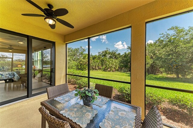 6907 Grand Estuary Trl Unit 104, Bradenton, FL 34212 - sunroom with ceiling fan, outdoor dining area, and healthy amount of natural light