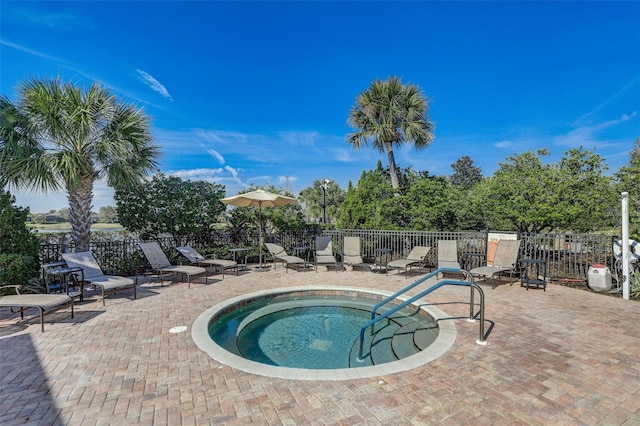 view of pool featuring fence, a patio, and a community hot tub