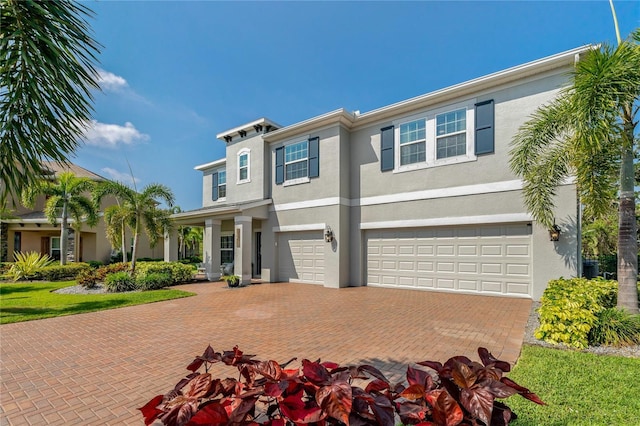 5805 49th Ct E, Ellenton, FL 34222 - view of front of property with stucco siding, an attached garage, and decorative driveway