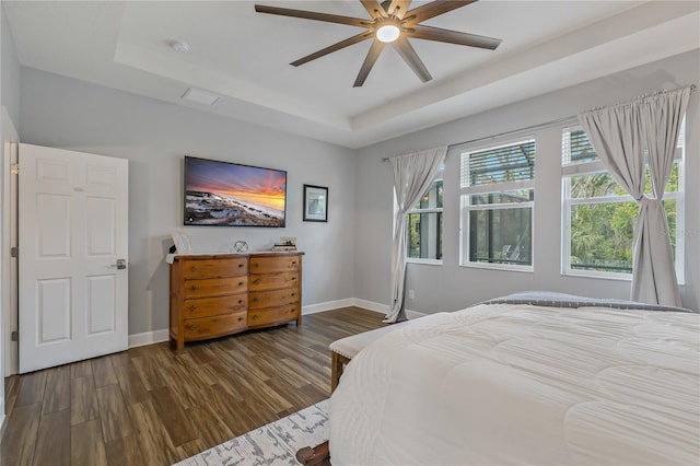 5805 49th Ct E, Ellenton, FL 34222 - bedroom featuring a tray ceiling, baseboards, and dark wood-style floors
