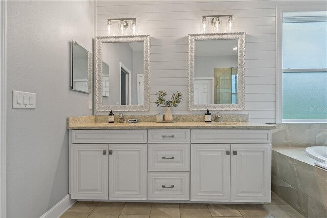 5805 49th Ct E, Ellenton, FL 34222 - bathroom with a shower stall, double vanity, a bath, and tile patterned floors