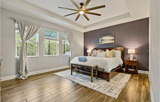 5805 49th Ct E, Ellenton, FL 34222 - bedroom featuring wood finished floors, baseboards, a tray ceiling, and ceiling fan