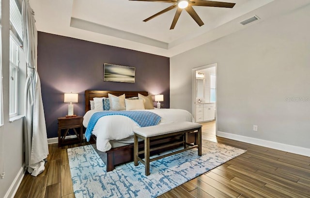 5805 49th Ct E, Ellenton, FL 34222 - bedroom with baseboards, wood finished floors, a raised ceiling, ensuite bathroom, and a ceiling fan