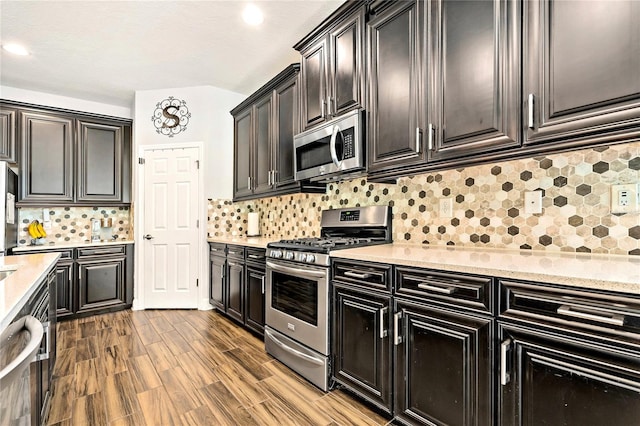 5805 49th Ct E, Ellenton, FL 34222 - kitchen featuring appliances with stainless steel finishes, backsplash, wood finished floors, light stone countertops, and recessed lighting