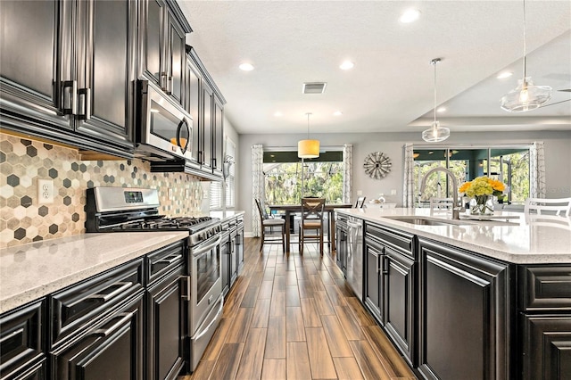 5805 49th Ct E, Ellenton, FL 34222 - kitchen featuring appliances with stainless steel finishes, dark cabinetry, a sink, recessed lighting, and dark wood-style floors