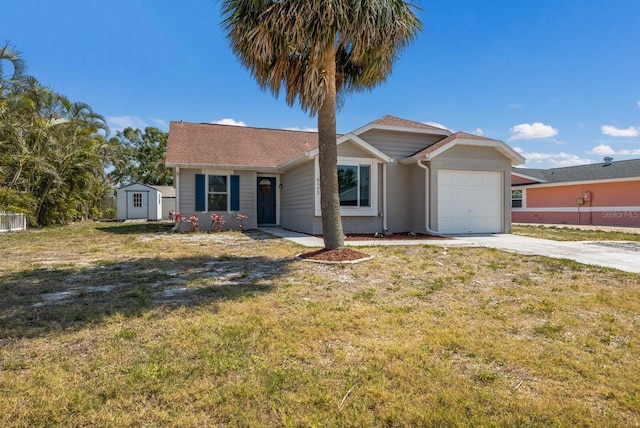 ranch-style home featuring a garage, a shed, concrete driveway, a front lawn, and an outbuilding