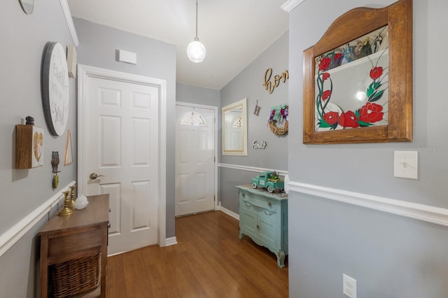 hallway featuring wood finished floors and baseboards