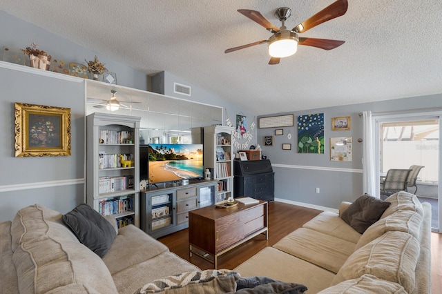 living area with ceiling fan, a textured ceiling, lofted ceiling, and wood finished floors