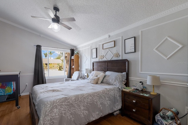 bedroom featuring a textured ceiling, wood finished floors, vaulted ceiling, crown molding, and ceiling fan