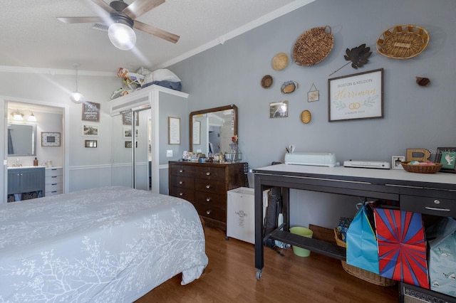 bedroom with wood finished floors, ornamental molding, and ensuite bath