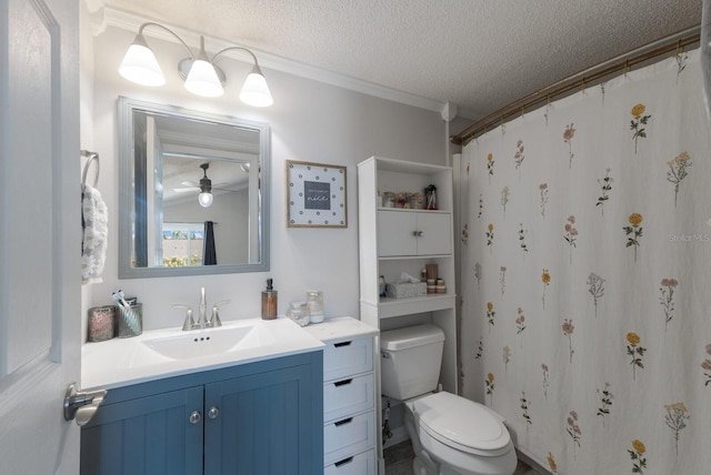 bathroom with a textured ceiling, crown molding, vanity, toilet, and a ceiling fan