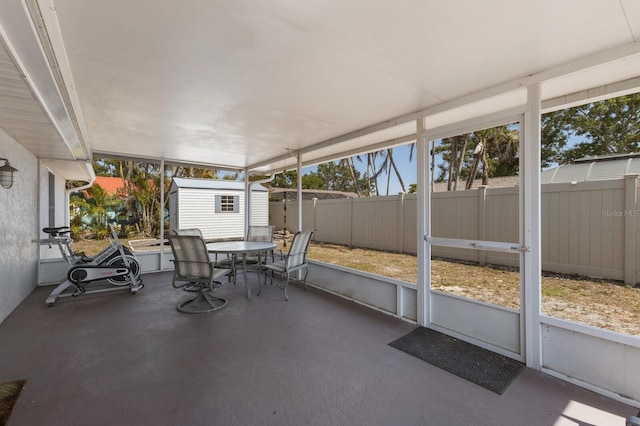 unfurnished sunroom with outdoor dining area