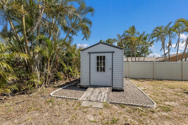 view of shed featuring fence
