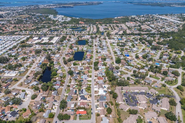 aerial overview of property's location featuring a large body of water and nearby suburban area