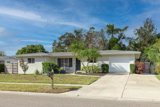 6442 Colonial Dr, Sarasota, FL 34231 - ranch-style home featuring a garage, a front lawn, and driveway