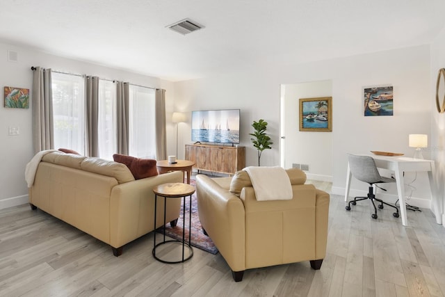 6442 Colonial Dr, Sarasota, FL 34231 - living area featuring light wood-style flooring and baseboards