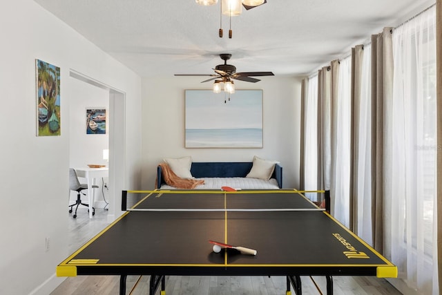 6442 Colonial Dr, Sarasota, FL 34231 - game room featuring healthy amount of natural light, a ceiling fan, wood finished floors, and baseboards