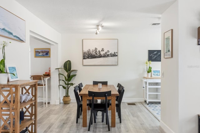 6442 Colonial Dr, Sarasota, FL 34231 - dining room with light wood-style floors and baseboards