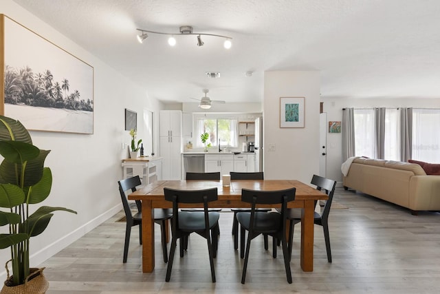 6442 Colonial Dr, Sarasota, FL 34231 - dining space featuring light wood-type flooring, a ceiling fan, and baseboards
