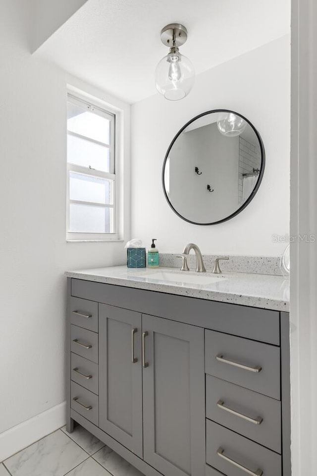 6442 Colonial Dr, Sarasota, FL 34231 - bathroom with baseboards, marble finish floors, and vanity