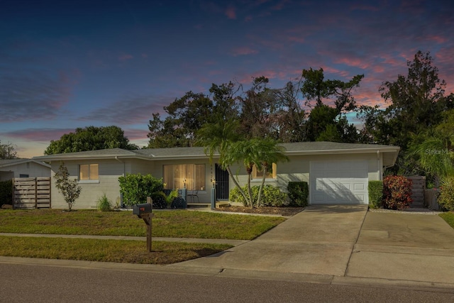 6442 Colonial Dr, Sarasota, FL 34231 - ranch-style house featuring a garage, a lawn, and driveway