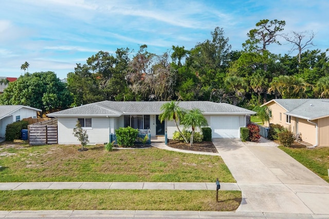 6442 Colonial Dr, Sarasota, FL 34231 - single story home featuring a garage, a front lawn, driveway, and a porch