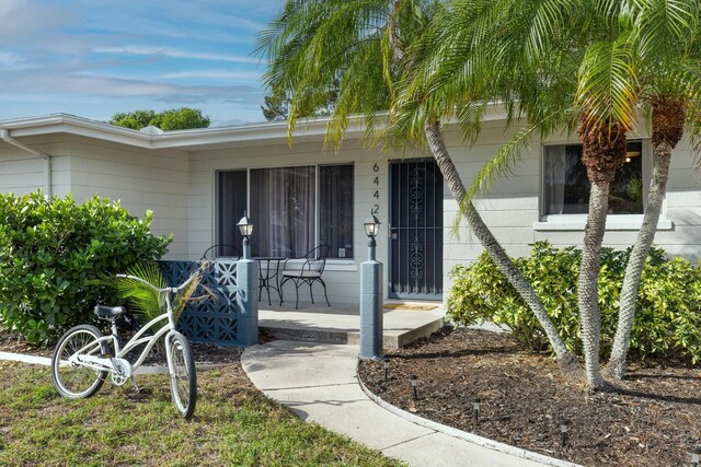 6442 Colonial Dr, Sarasota, FL 34231 - view of exterior entry featuring a porch