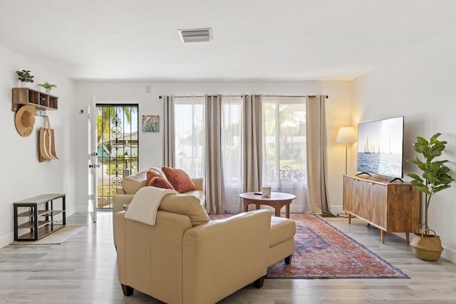 6442 Colonial Dr, Sarasota, FL 34231 - living room featuring light wood-style floors and baseboards
