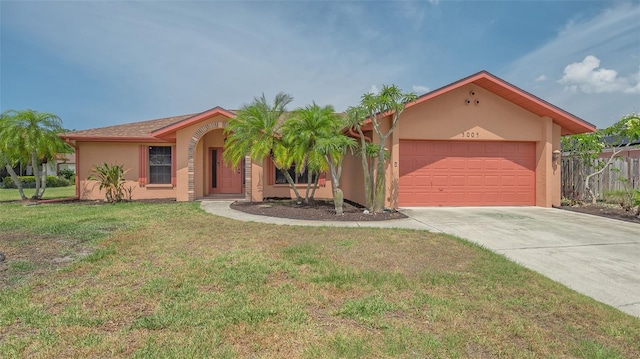 5004 32nd St E, Bradenton, FL 34203 - view of front of property featuring stucco siding, an attached garage, concrete driveway, and a front lawn