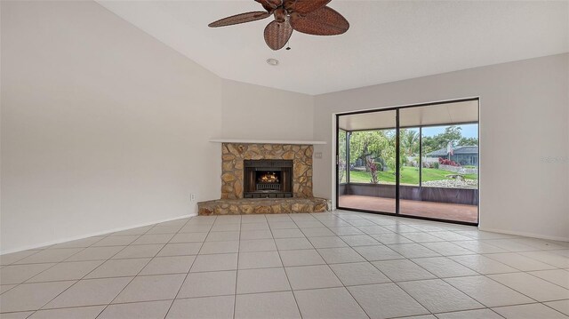 5004 32nd St E, Bradenton, FL 34203 - unfurnished living room with vaulted ceiling, light tile patterned floors, a ceiling fan, a fireplace, and baseboards