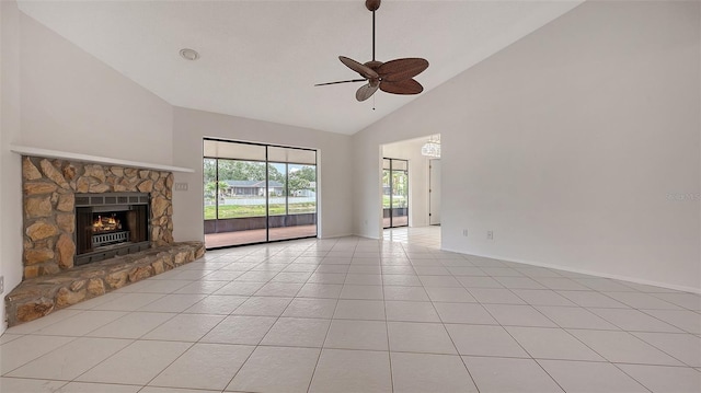 5004 32nd St E, Bradenton, FL 34203 - unfurnished living room with high vaulted ceiling, a ceiling fan, light tile patterned flooring, a stone fireplace, and baseboards