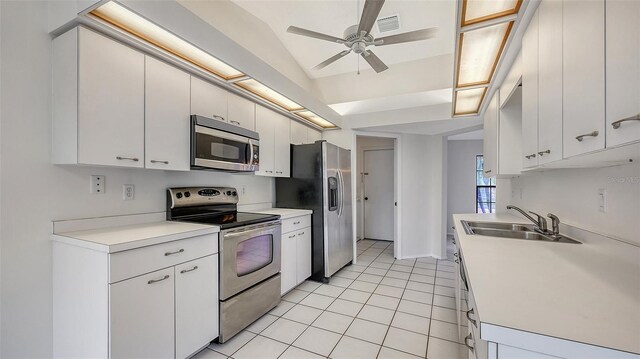 5004 32nd St E, Bradenton, FL 34203 - kitchen featuring stainless steel appliances, a sink, ceiling fan, light tile patterned floors, and light countertops