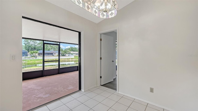 5004 32nd St E, Bradenton, FL 34203 - spare room with a chandelier, lofted ceiling, baseboards, and light tile patterned flooring