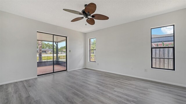 5004 32nd St E, Bradenton, FL 34203 - spare room featuring wood finished floors, ceiling fan, baseboards, and a textured ceiling