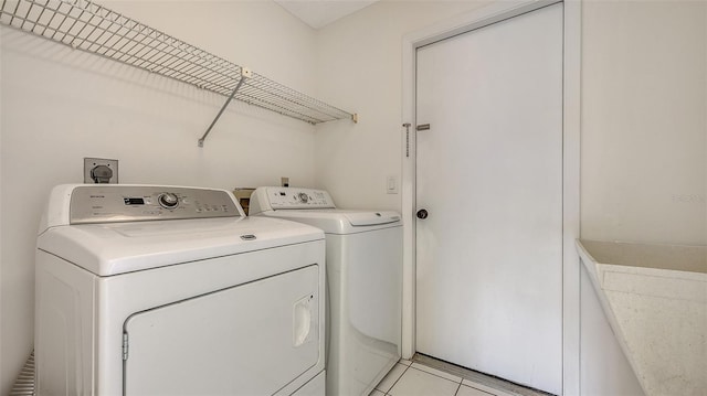 5004 32nd St E, Bradenton, FL 34203 - laundry area with washer and clothes dryer and light tile patterned flooring