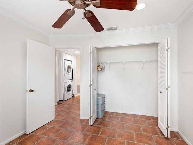 635 N Jefferson Ave Unit 635, Sarasota, FL 34237 - unfurnished bedroom with stacked washer / dryer, crown molding, a closet, ceiling fan, and baseboards