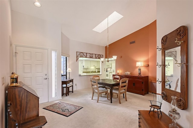 6096 Wilshire Blvd Unit 9, Sarasota, FL 34238 - foyer featuring a skylight, carpet, high vaulted ceiling, and a chandelier