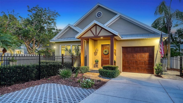 1934 Bougainvillea St, Sarasota, FL 34239 - view of front facade with stucco siding, a garage, driveway, and a gate