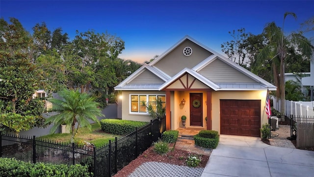 1934 Bougainvillea St, Sarasota, FL 34239 - view of front facade with an attached garage, concrete driveway, and stucco siding
