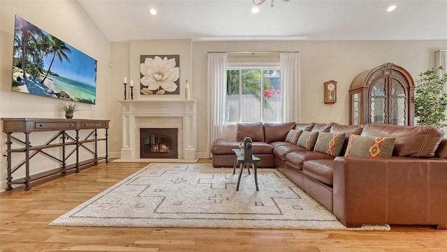 1934 Bougainvillea St, Sarasota, FL 34239 - living room featuring recessed lighting, wood finished floors, a fireplace with flush hearth, vaulted ceiling, and baseboards