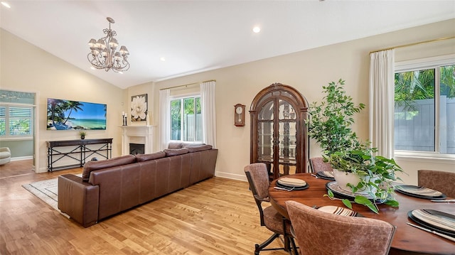 1934 Bougainvillea St, Sarasota, FL 34239 - living room featuring light wood-style flooring, vaulted ceiling, a chandelier, baseboards, and recessed lighting