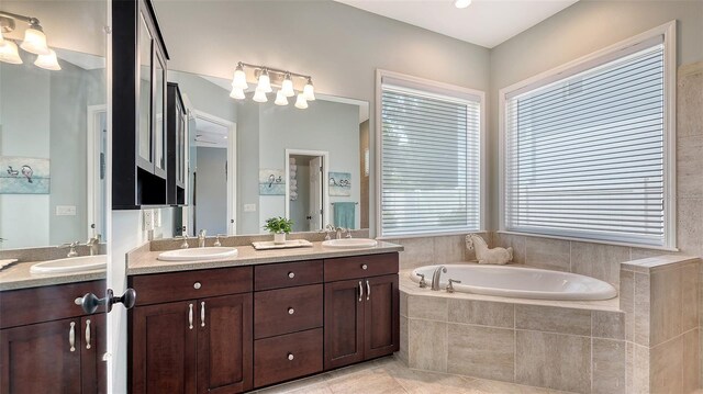 1934 Bougainvillea St, Sarasota, FL 34239 - bathroom featuring double vanity, a garden tub, and tile patterned floors