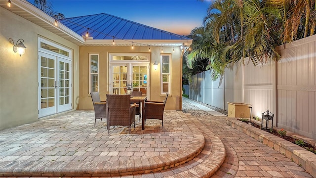 1934 Bougainvillea St, Sarasota, FL 34239 - patio terrace at dusk with french doors, a patio, and outdoor dining space