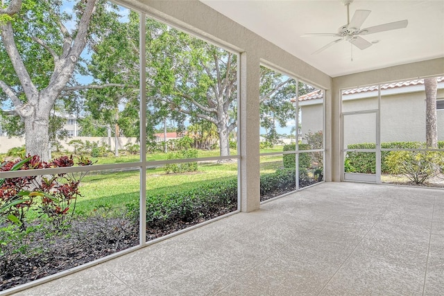 unfurnished sunroom featuring ceiling fan