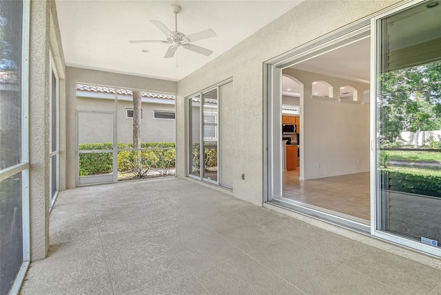 unfurnished sunroom with a textured wall