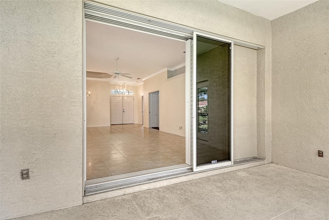 doorway to property featuring ceiling fan
