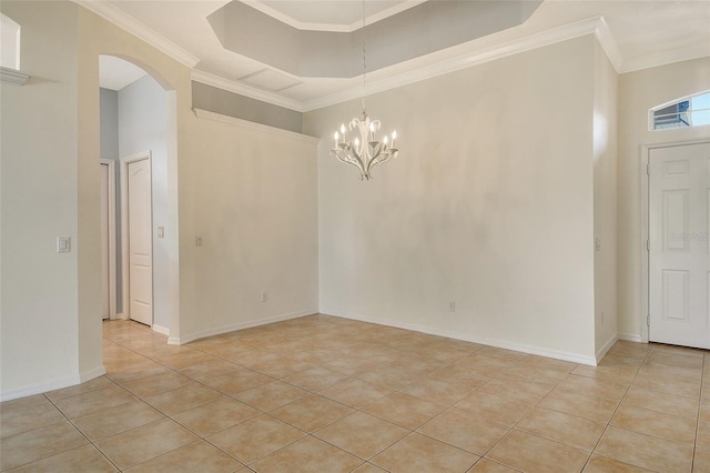 empty room with light tile patterned floors, crown molding, arched walkways, a chandelier, and baseboards